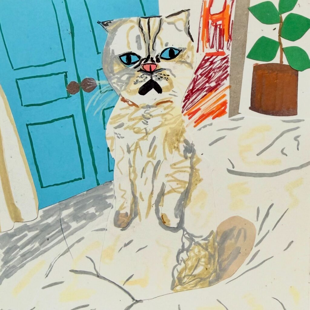 A paper cut cat on a couch in front of a blue door